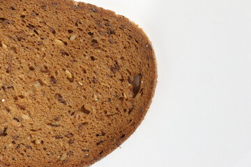  a slice of wholemeal bread with nuts on white background