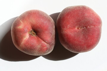 Doughnut or Saturn peach (Prunus persica f. compressa) isolated on white background
