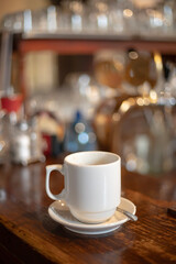A cup of aromatic coffee in a white cup in a cafe on a table