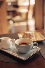 A cup of aromatic coffee in a white cup in a cafe on a table