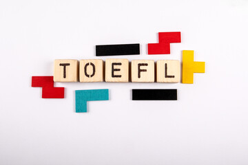 TOEFL. Word from wooden alphabet blocks on white background