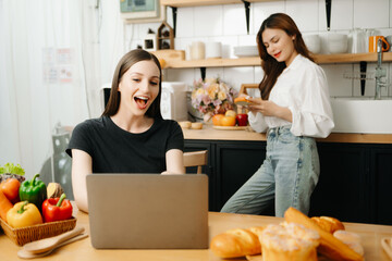 Image of newlywed couple cooking at home. Asia young couple cooking together with Bread and fruit in cozy kitchen .