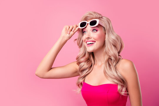 Profile photo of lovely astonished lady arm touch sunglass look empty space ad isolated on pink color background