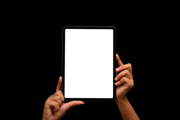 Woman hands holding digital tablet against black background. White empty screen for your text or promotional content
