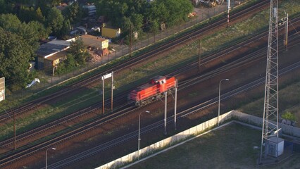 Aerial of Red Electric Locomotive Engine on Multiple Tracks Railway
