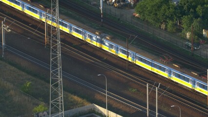 Aerial of Electric Passenger Train on Multiple Tracks Railway