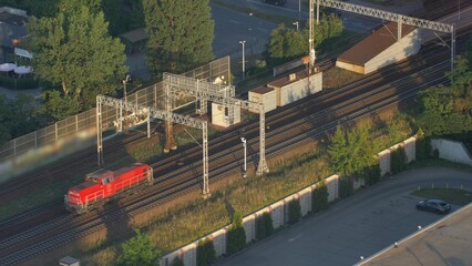 Aerial of Red Electric Locomotive Engine on Multiple Tracks Railway