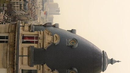 Slow-motion vertical shot of a building's spire in downtown Paris, France - Powered by Adobe