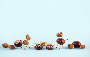 Animals made of acorns and horse chestnuts with toothpicks and lighting matches for legs. Blue...