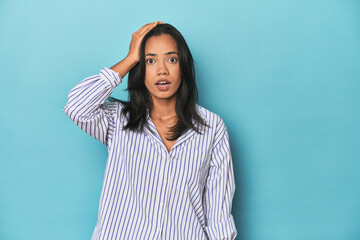 Fototapeta premium Filipina young woman on blue studio being shocked, she has remembered important meeting.