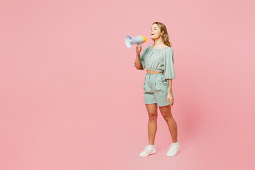 Full body side view young happy woman she wears casual clothes hold in hand megaphone scream...