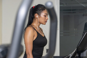 Sweaty woman uses treadmill in gym
