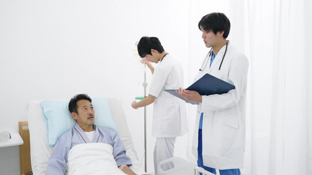 病床で医師と話す入院患者
