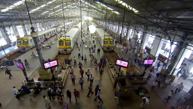Timelapse of Churchgate station in the day showing rush hour commuters in Mumbai city. Timelapse at busy Indian railway station. Mumbai local train