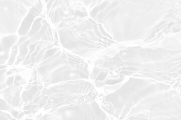 White water with ripples on the surface. Defocus blurred transparent white colored clear calm water surface texture with splashes and bubbles. Water waves with shining pattern texture background.