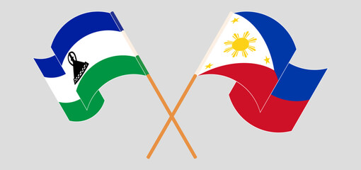 Crossed and waving flags of Lesotho and the Philippines