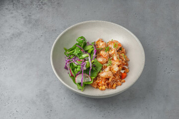 fried rice with shrimps and tofu on gray background