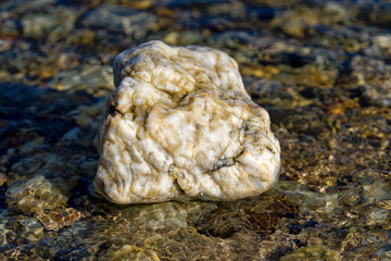 Close-up of white stone at pebble beach at Giens Peninsula on a sunny late spring day. Photo taken...
