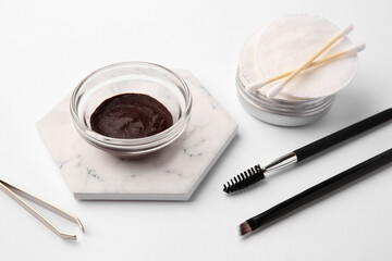 Eyebrow henna and professional tools on white background, closeup