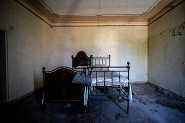 wrought iron double bed in an abandoned house
