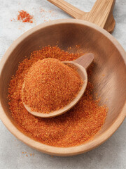 "Spice Infusion: Pouring Chilli Flakes into a Wooden Dish, Adding a Fiery Kick to Culinary Creations"