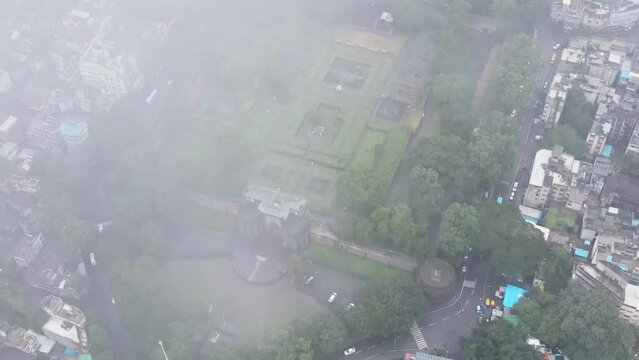 Aerial footage of Pune city from clouds to Shaniwar Wada, a historical fortification built by the Peshwas in Pune, Maharashtra. Fort in India