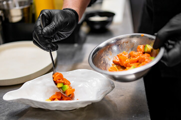 chef cooking Seviche with salmon and avocado on kitchen