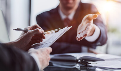 colleagues brainstorm work with documents at briefing in boardroom