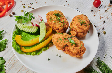 Fried chicken steak or schnitzel with mashed potatoes on black stone table.