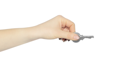 A woman's hand holds a key in her hand, isolated from the background. The concept of security, house trade.