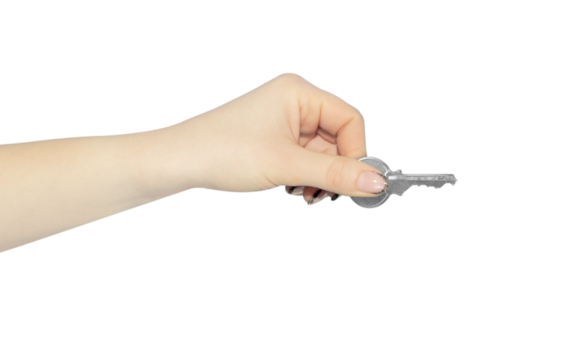 A woman's hand holds a key in her hand, isolated from the background. The concept of security, house trade.