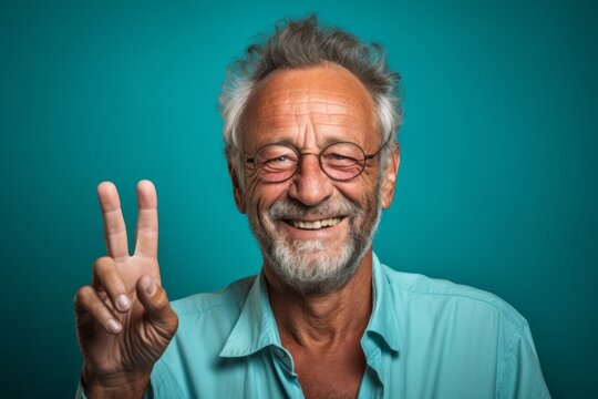 Close-up portrait photography of a grinning mature man making the l sign against a turquoise blue background. With generative AI technology