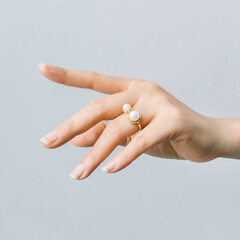 Pearl ring on a girl's finger.