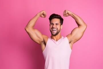 Lifestyle portrait photography of a happy boy in his 20s making a i'm strong gesture showing muscles against a hot pink background. With generative AI technology