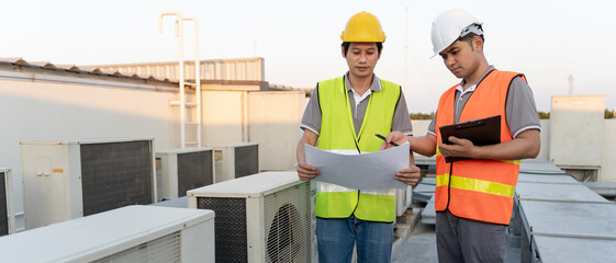 Engineers use blueprint check air condition systems on site. Contractor and inspector inspection compressor during project. maintenance team check quality assurance. Audit, inspect, quality control.