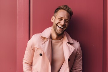 Obraz premium Lifestyle portrait photography of a happy boy in his 30s covering one eye against a dusty rose background. With generative AI technology