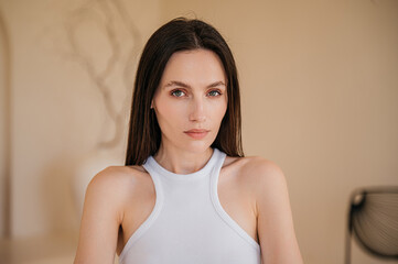 Model with healthy and perfect smooth skin against blurred pastel background