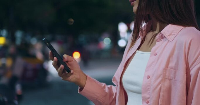 Woman hands use cell phone for serfing networking digital world close-up. Hold in hand mobilephone. Concept digital world and sharing and reading sms display. Successful share browsing receive digital