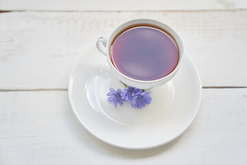 Delicious chicory drink, cups and saucers on a wooden table with a place to copy. A healthy drink made from chicory. High quality photo