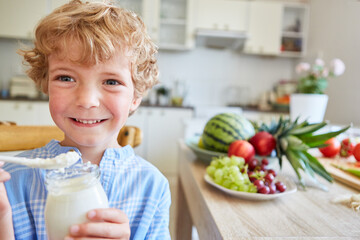 Smiling boy holding parfait jar