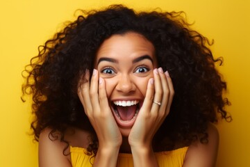 Close-up portrait photography of a grinning girl in her 20s putting hands on the face in a gesture of terror against a bright yellow background. With generative AI technology