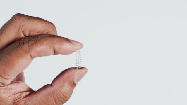Hand holds a Micro Spring