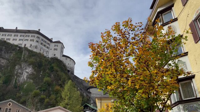 Residential buildings and Kufstein Fortress on top of mountain during fall season. European cultural trip concept