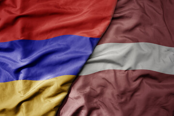 big waving national colorful flag of armenia and national flag of latvia .