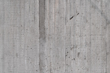 Concete wall of a building with weathered facade. Traces like lines and dots from paving out the...