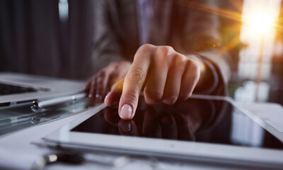 close up. businessman pressing his finger on the screen of the digital tablet