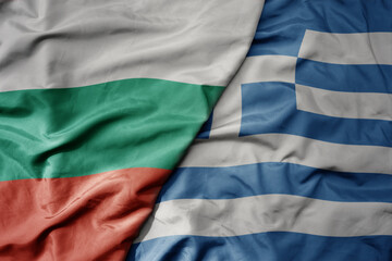 big waving national colorful flag of bulgaria and national flag of greece .