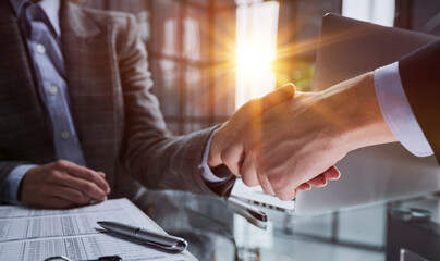 Agent and client shaking hands after signed document and done business deal for transfer right of property.