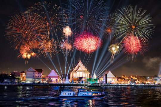 Cruise sightseeing with annual colorful fireworks and light show at Wat Kalayanamit temple on Chao Phraya river in the night