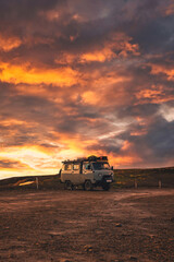 Van parked with sunset sky on top of mountain in Icelandic Highlands on summer at Iceland